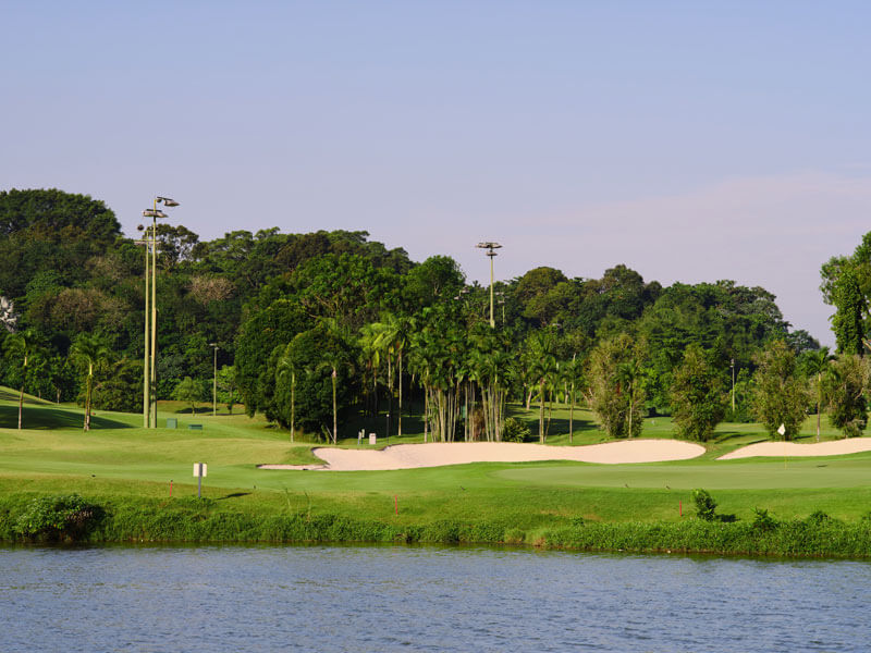 Irrigation pond alongside fairways and sand traps showing pristine water care for golf courses.