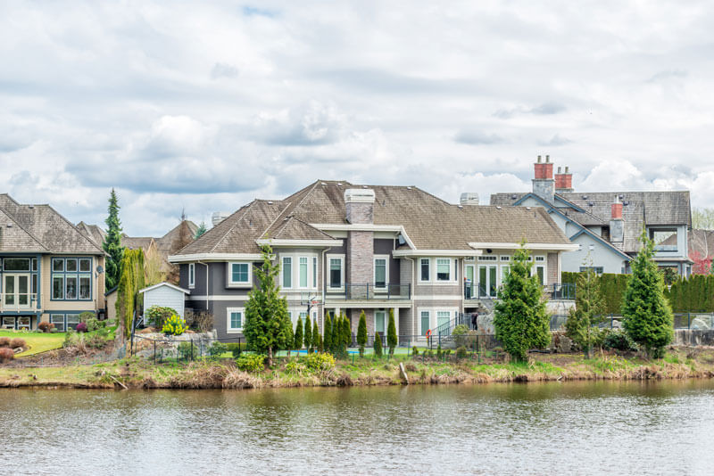 Pristine residential lake bordering neighborhood properties within homeowners associations.