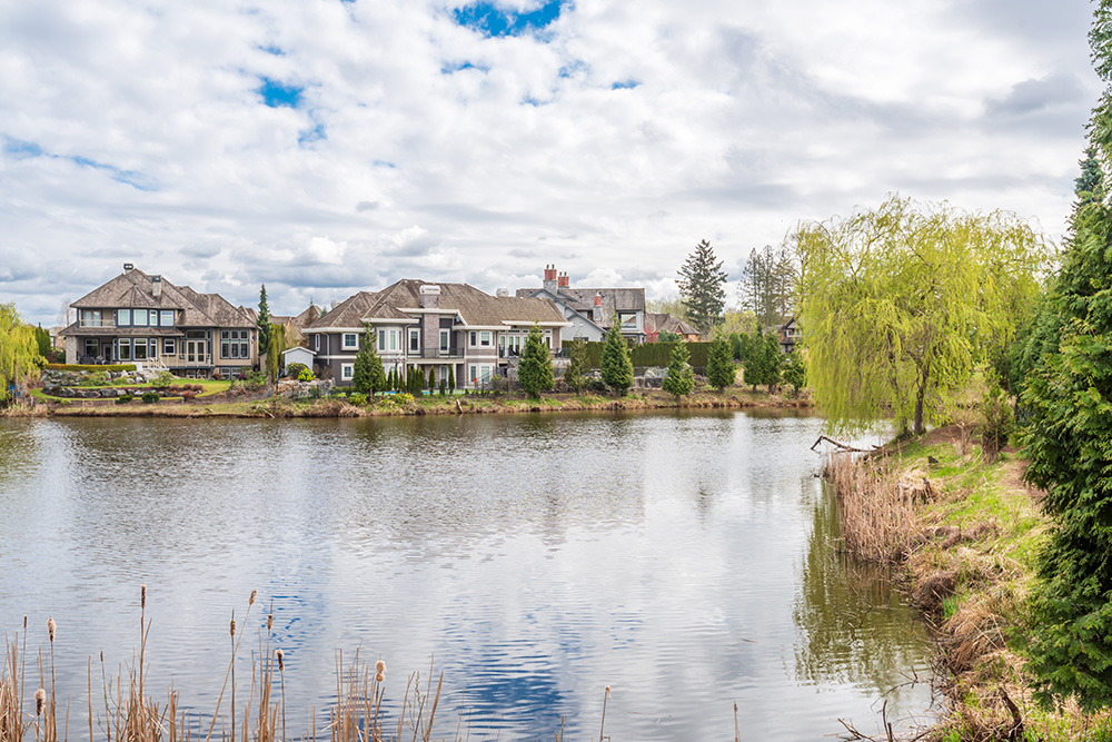 Waterfront community homes overlooking a clean residential lake maintained through our membership program.