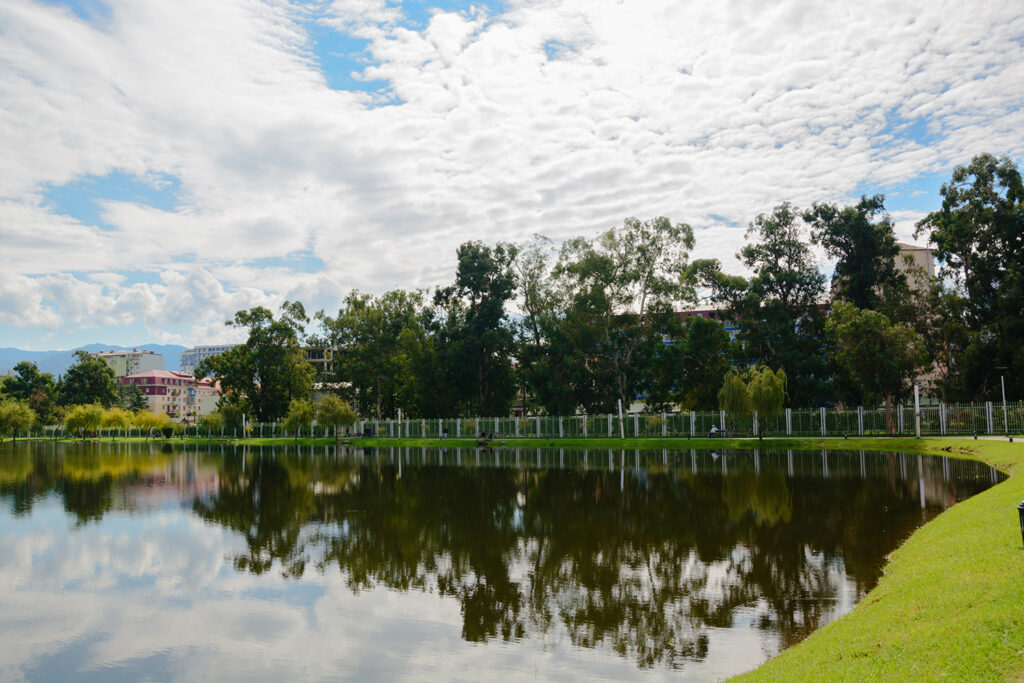 Clean community lake with tree-lined banks maintained by Rigero water restoration services.